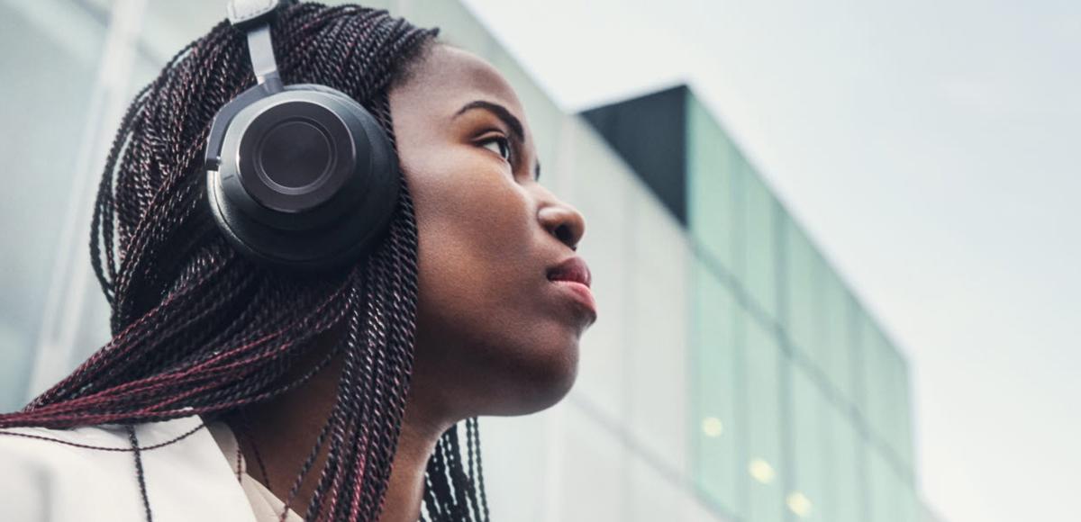 Woman wearing headphones with eyes directed up